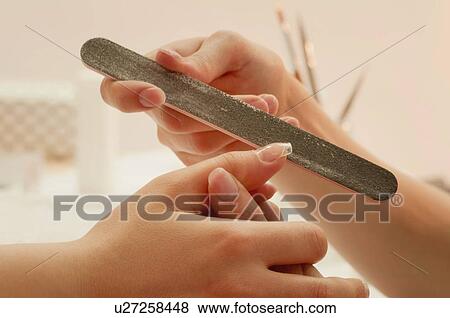 Woman having manicure View Large Photo Image Stock Photo - Woman having manicure. Fotosearch