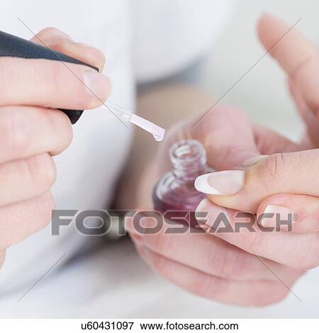 Woman having manicure View Large Photo Image Stock Photo - Woman having manicure. Fotosearch