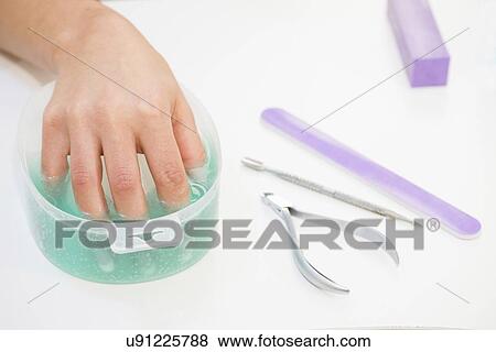 Woman having manicure View Large Photo Image Stock Photo - Woman having manicure. Fotosearch