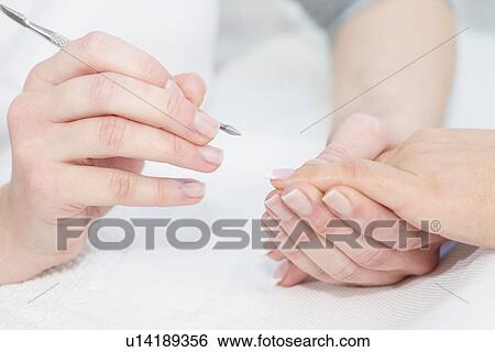 Stock Photograph - Woman having manicure. Fotosearch