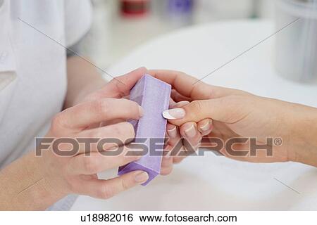 Woman having manicure View Large Photo Image Stock Photograph - Woman having manicure. Fotosearch