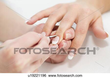 Stock Photograph - Woman having manicure. Fotosearch
