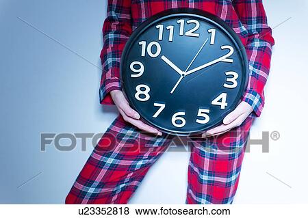 Woman holding clock View Large Photo Image Stock Photo - Woman holding clock. Fotosearch