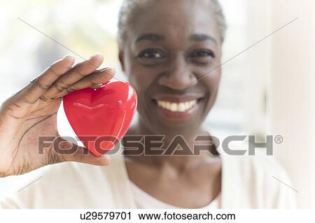 Woman holding heart shape View Large Photo Image Stock Image - Woman holding heart shape. Fotosearch