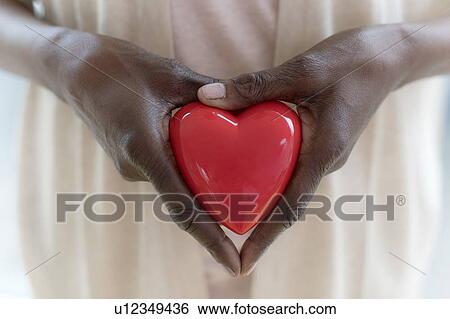 Woman holding heart shape View Large Photo Image Stock Photograph - Woman holding heart shape. Fotosearch