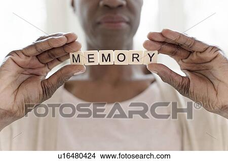 Picture - Woman holding word memory. Fotosearch