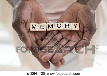 Stock Image - Woman holding word memory. Fotosearch