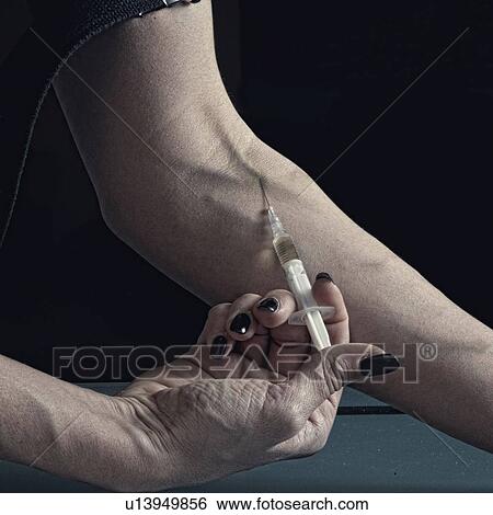 Stock Photograph - Woman injecting heroin. Fotosearch