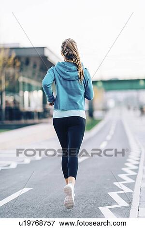 Woman jogging in city View Large Photo Image Stock Photo - Woman jogging in city. Fotosearch