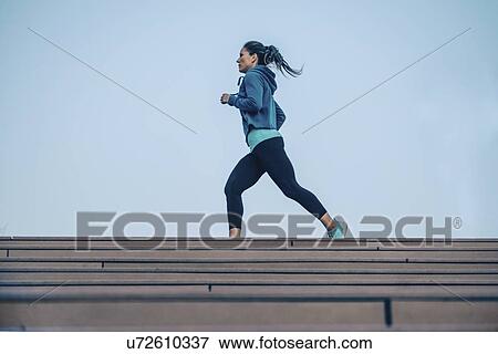 Woman jogging in city View Large Photo Image Stock Photo - Woman jogging in city. Fotosearch
