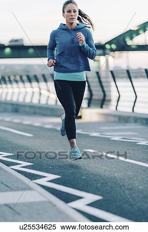 Woman jogging in city View Large Photo Image Stock Photography - Woman jogging in city. Fotosearch