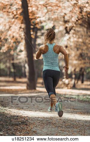 Woman jogging outdoors View Large Photo Image Picture - Woman jogging outdoors. Fotosearch
