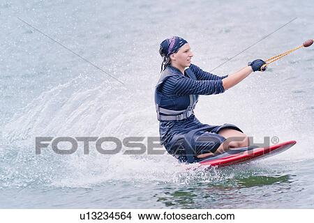 Picture - Woman kneeboarding. Fotosearch