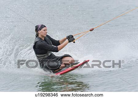 Woman kneeboarding View Large Photo Image Stock Photograph - Woman kneeboarding. Fotosearch