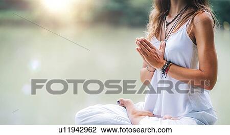 Woman meditating by a lake View Large Photo Image Stock Image - Woman meditating by a lake. Fotosearch