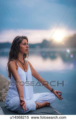 Woman meditating by a lake View Large Photo Image Stock Photography - Woman meditating by a lake. Fotosearch