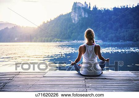 Stock Photograph - Woman meditating. Fotosearch