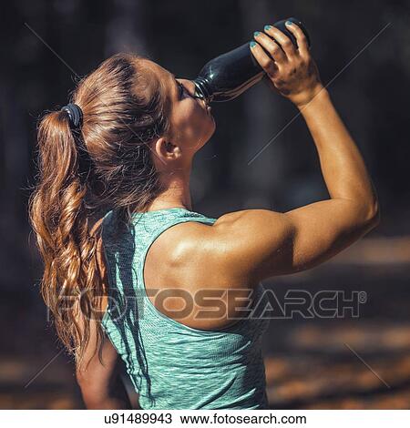 Woman resting and drinking water View Large Photo Image Stock Image - Woman resting and drinking water. Fotosearch