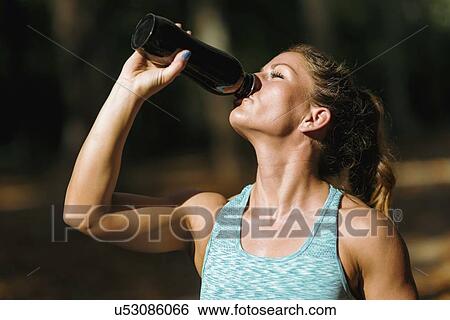 Woman resting and drinking water View Large Photo Image Stock Photograph - Woman resting and drinking water. Fotosearch