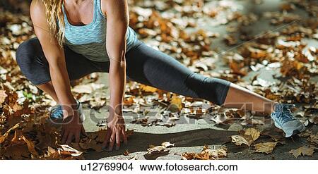 Picture - Woman stretching in the park. Fotosearch