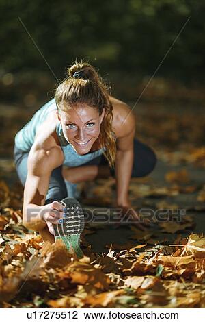 Woman stretching in the park View Large Photo Image Stock Image - Woman stretching in the park. Fotosearch