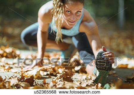 Woman stretching in the park View Large Photo Image Stock Photo - Woman stretching in the park. Fotosearch