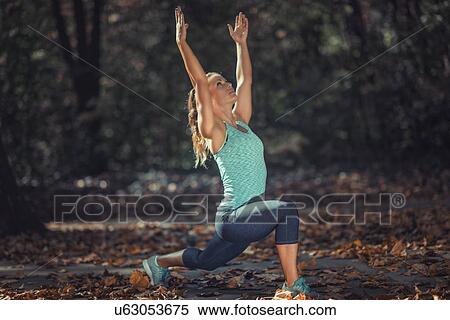Stock Photography - Woman stretching in the park. Fotosearch