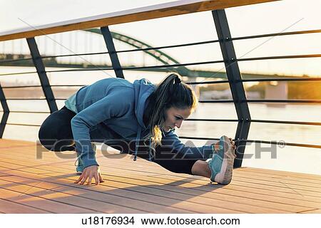 Woman stretching on bridge View Large Photo Image Picture - Woman stretching on bridge. Fotosearch