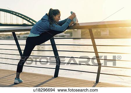 Picture - Woman stretching on bridge. Fotosearch