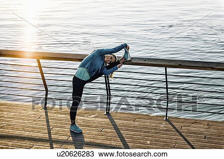 Woman stretching on bridge View Large Photo Image Stock Image - Woman stretching on bridge. Fotosearch