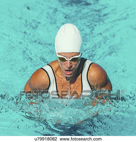 Stock Image - Woman swimming breaststroke. Fotosearch