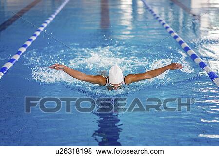Stock Photo - Woman swimming butterfly. Fotosearch