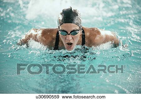 Stock Photo - Woman swimming butterfly. Fotosearch