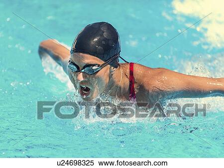 Stock Photography - Woman swimming butterfly. Fotosearch