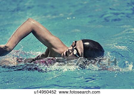 Stock Image - Woman swimming front crawl. Fotosearch