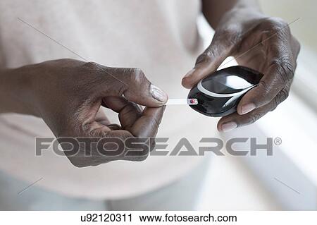 Woman testing blood glucose View Large Photo Image Stock Image - Woman testing blood glucose. Fotosearch
