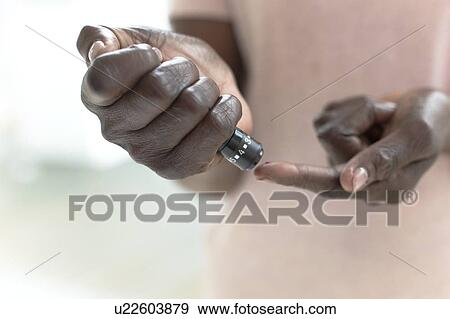 Woman testing blood glucose View Large Photo Image Stock Photo - Woman testing blood glucose. Fotosearch