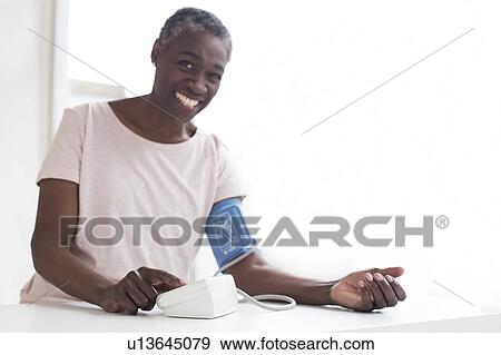 Woman testing blood pressure View Large Photo Image Stock Photo - Woman testing blood pressure. Fotosearch
