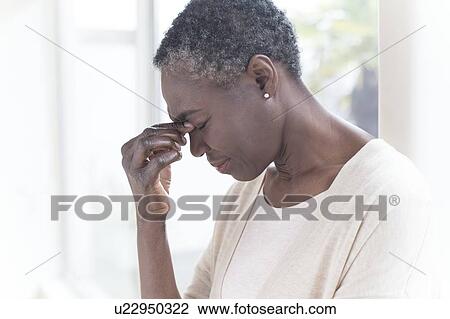 Woman touching bridge of nose View Large Photo Image Stock Image - Woman touching bridge of nose. Fotosearch