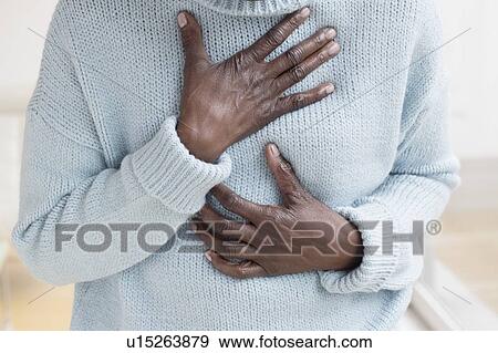 Woman touching chest in pain View Large Photo Image Stock Photo - Woman touching chest in pain. Fotosearch