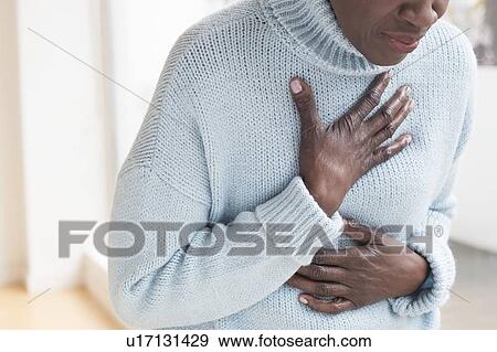 Woman touching chest in pain View Large Photo Image Stock Photo - Woman touching chest in pain. Fotosearch