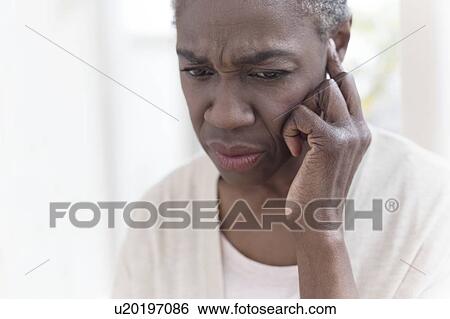 Woman touching ear View Large Photo Image Stock Photograph - Woman touching ear. Fotosearch
