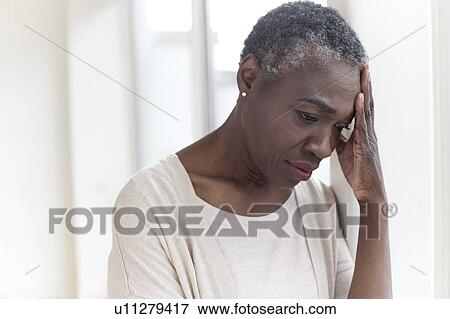 Stock Photo - Woman touching head. Fotosearch