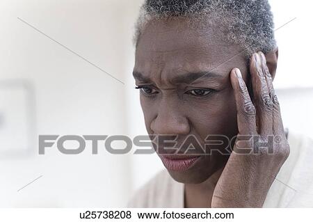 Stock Photo - Woman touching head. Fotosearch
