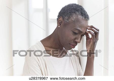 Stock Photo - Woman touching head. Fotosearch