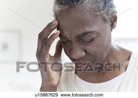 Woman touching head with hand View Large Photo Image Stock Photo - Woman touching head with hand. Fotosearch