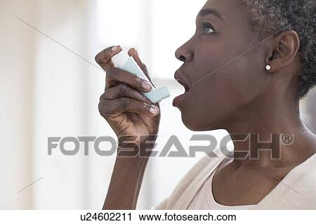 Woman using inhaler View Large Photo Image Stock Image - Woman using inhaler. Fotosearch