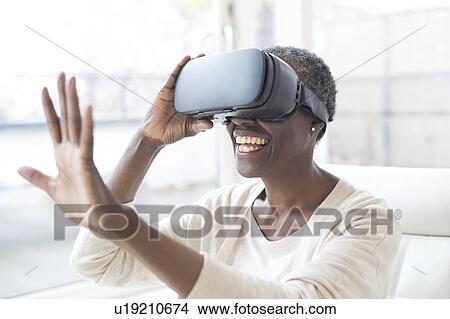 Woman wearing VR headset View Large Photo Image Picture - Woman wearing VR headset. Fotosearch