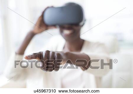 Woman wearing VR headset View Large Photo Image Stock Image - Woman wearing VR headset. Fotosearch
