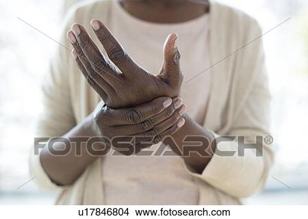 Woman with hand pain View Large Photo Image Picture - Woman with hand pain. Fotosearch